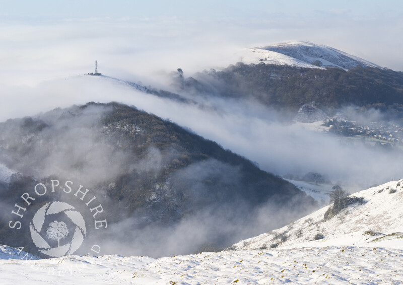 Winter mist rolls over Helmeth, Hazler and Ragleth hills, seen from Caradoc, Shropshire.